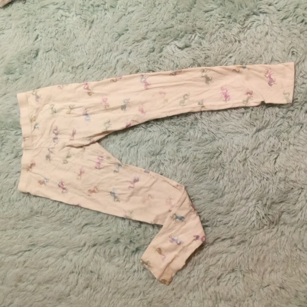 Girls size 14-16 white leggings with purple, pink, and blue colored unicorns.